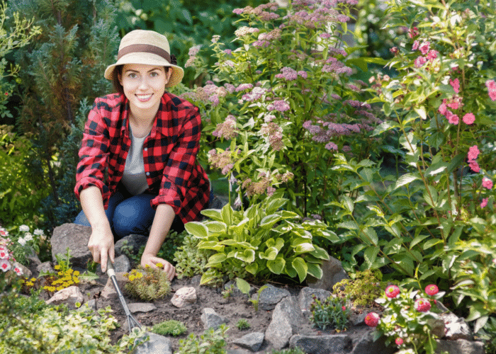 Woman gardener weeding weeds